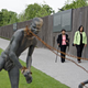 People walk past a sculpture at the Equal Justice Initiative’s National Memorial for Peace and Justice in Montgomery, Ala., on Monday.